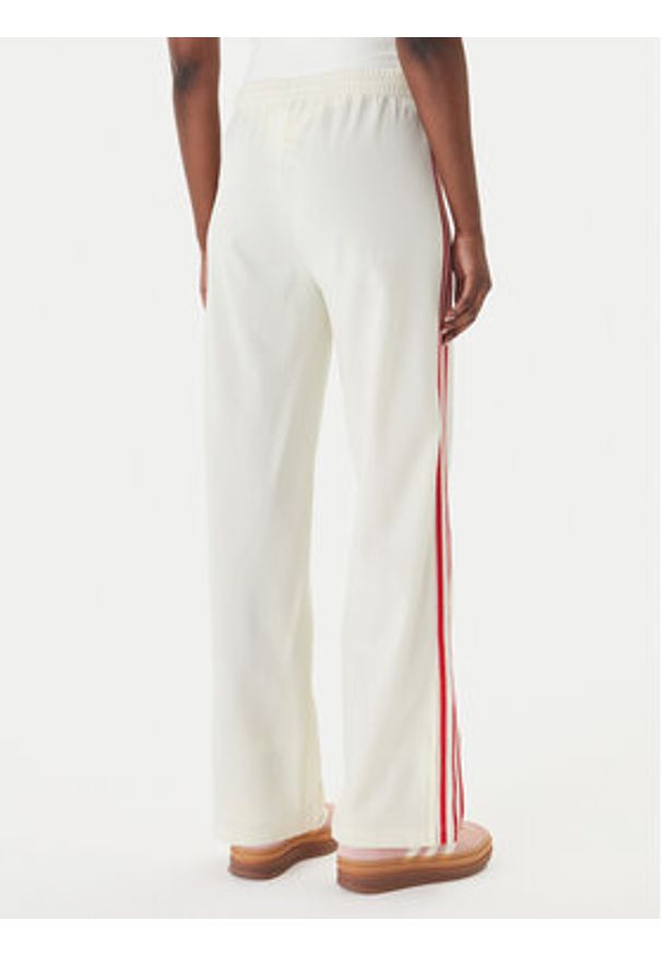 Adidas - adidas Spodnie dresowe Firebird KQ8056 Beżowy Loose Fit. Kolor: beżowy. Materiał: syntetyk