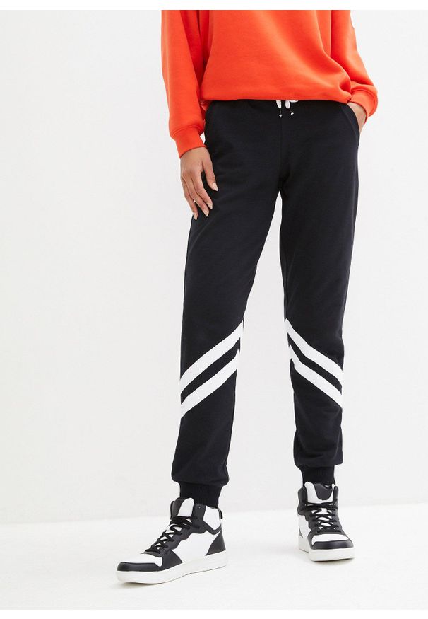 bonprix - Spodnie dresowe z paskami. Kolor: czarny. Materiał: dresówka. Styl: sportowy