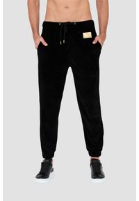 MOSCHINO Czarne welurowe spodnie dresowe. Kolor: czarny. Materiał: dresówka, welur #1