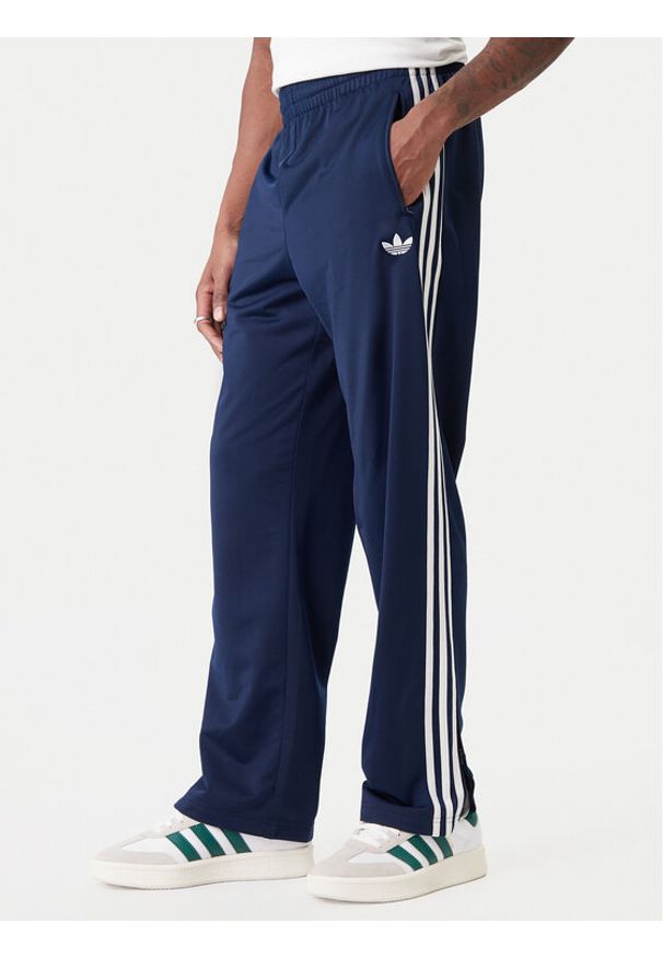 Adidas - adidas Spodnie dresowe Firebird KD8316 Granatowy Loose Fit. Kolor: niebieski. Materiał: syntetyk