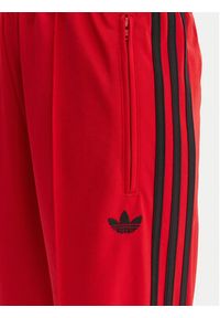 Adidas - adidas Spodnie dresowe Firebird Classic KD3648 Czerwony Regular Fit. Kolor: czerwony. Materiał: syntetyk #2