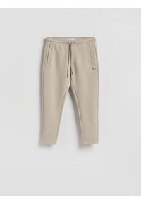 Reserved - Spodnie dresowe slim - jasnoszary. Kolor: szary. Materiał: dresówka #1