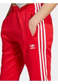 Adidas - adidas Spodnie dresowe adicolor SST IK6603 Czerwony Slim Fit. Kolor: czerwony. Materiał: bawełna