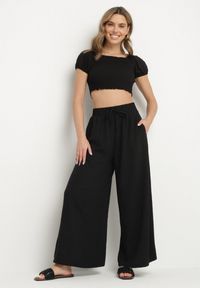 Born2be - Czarne Szerokie Spodnie Typu Palazzo z Wiązaniem Ulialitia. Okazja: na co dzień. Stan: podwyższony. Kolor: czarny. Styl: elegancki, casual