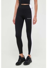 TOMMY HILFIGER - Tommy Hilfiger legginsy damskie kolor czarny wzorzyste. Kolor: czarny. Materiał: poliester, skóra, dzianina, materiał. Sport: fitness #1