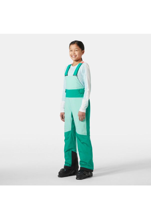 Dziewczęcy kombinezon narciarski Helly Hansen Stellar. Kolor: zielony. Sezon: zima. Sport: narciarstwo