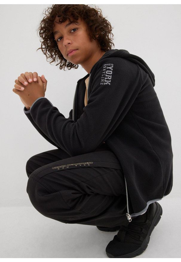 bonprix - Spodnie typu loose fit z podszewką z dżerseju. Kolor: czarny. Materiał: jersey