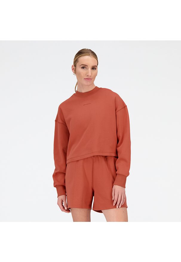 Bluza damska New Balance WT23555MHY – pomarańczowa. Kolor: pomarańczowy. Materiał: materiał, bawełna, dresówka, prążkowany