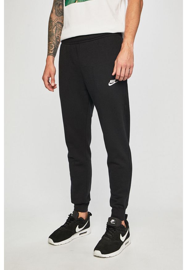 Nike Sportswear - Spodnie BV2671. Kolor: czarny. Materiał: bawełna, poliester, materiał, dzianina. Wzór: gładki