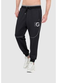 Dolce and Gabbana - DOLCE & GABBANA Czarne spodnie dresowe z dużym logo. Kolor: czarny. Materiał: poliester #4