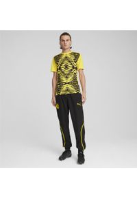 Puma - Męskie spodnie przedmeczowe z tkaniny Borussia Dortmund PUMA Black Faster Yellow. Kolor: czarny, wielokolorowy, żółty. Materiał: tkanina. Sport: piłka nożna