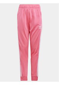 Adidas - adidas Spodnie dresowe adicolor SST IN8492 Różowy Regular Fit. Kolor: różowy. Materiał: syntetyk #1