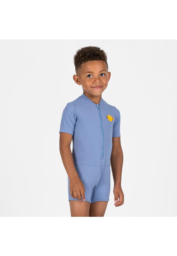 NABAIJI - Krótki kombinezon kąpielowy dla malucha Nabaiji. Kolor: niebieski. Materiał: poliamid, materiał, elastan. Długość: krótkie. Wzór: kolorowy