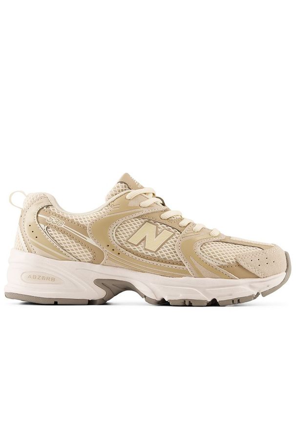 Buty młodzieżowe New Balance G5303QO - beżowe. Kolor: beżowy. Materiał: materiał, syntetyk, guma. Szerokość cholewki: normalna
