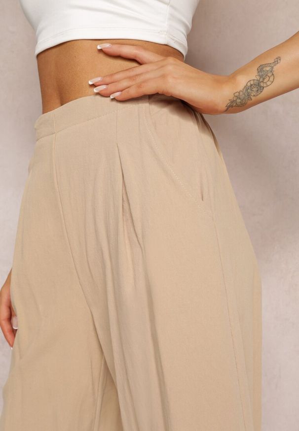 Renee - Beżowe Szerokie Spodnie z Gumką w Pasie z Bawełny Zonaeve. Okazja: na co dzień. Stan: podwyższony. Kolor: beżowy. Materiał: bawełna. Styl: casual