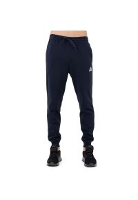 Adidas - Spodnie adidas Essentials Fleece Regular Tapered HL2231 - granatowe. Kolor: niebieski. Materiał: dresówka, bawełna, tkanina, poliester #1