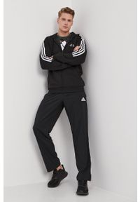 Adidas - adidas Spodnie męskie kolor czarny gładkie. Kolor: czarny. Wzór: gładki