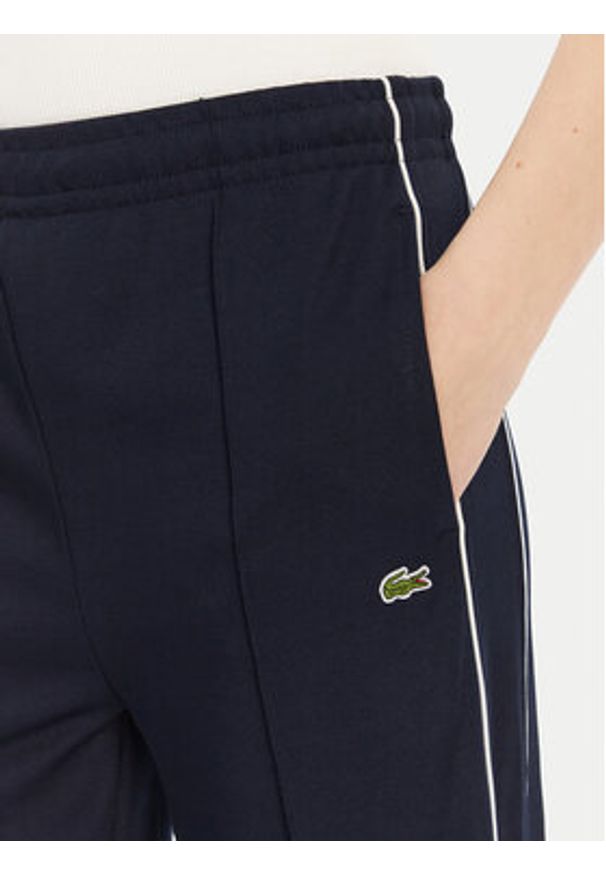 Lacoste Spodnie dresowe XF7260 Granatowy Relaxed Fit. Kolor: niebieski. Materiał: syntetyk, bawełna