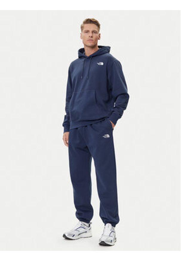 The North Face Spodnie dresowe Essential NF0A8C1F Granatowy Relaxed Fit. Kolor: niebieski. Materiał: syntetyk