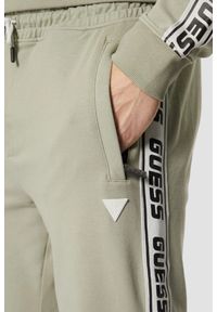 Guess - GUESS Zielone męskie spodnie dresowe z lampasami New Arlo, Rozmiar XL. Kolor: zielony. Materiał: dresówka #3