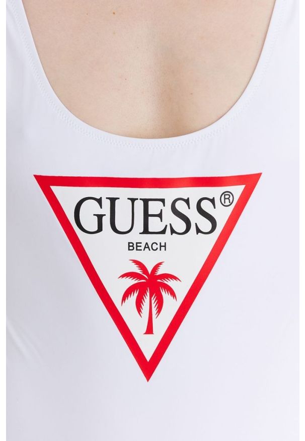 Guess - GUESS Biały strój kąpielowy z trójkątnym logo. Kolor: biały. Materiał: poliamid. Wzór: aplikacja, nadruk