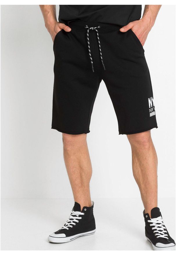 bonprix - Bermudy dresowe z dołem nogawek bez obszycia. Kolor: czarny. Materiał: dresówka. Wzór: nadruk