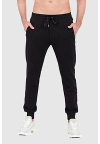 Dolce and Gabbana - DOLCE & GABBANA Czarne spodnie dresowe z haftowanym logo. Kolor: czarny. Materiał: bawełna. Wzór: haft