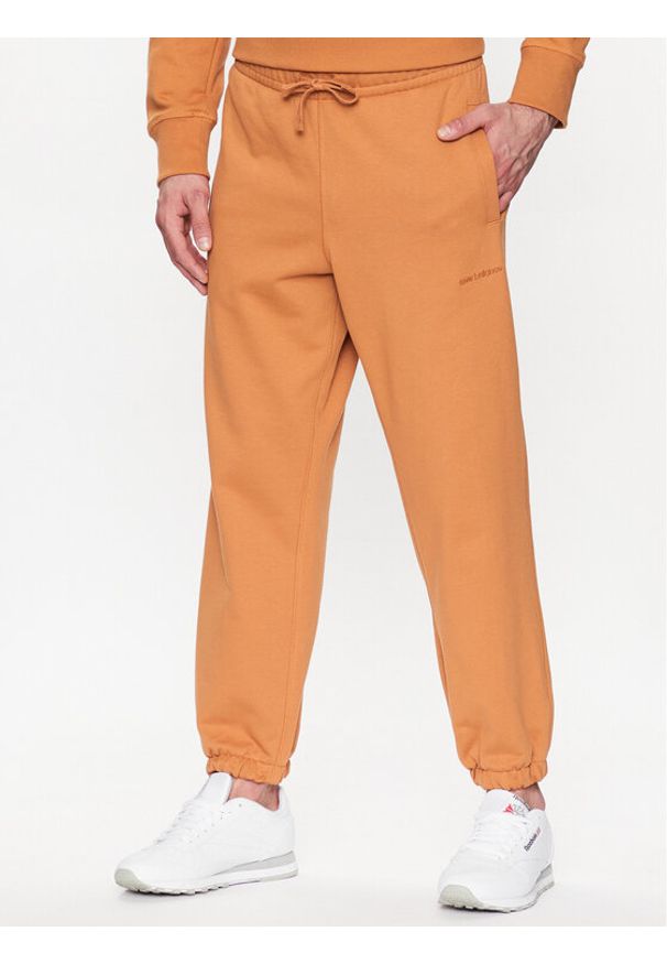 New Balance Spodnie dresowe MP23551 Pomarańczowy Relaxed Fit. Kolor: pomarańczowy. Materiał: bawełna