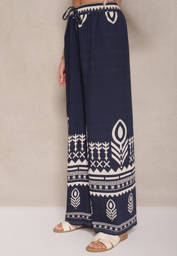 Renee - Granatowe Szerokie Spodnie z Wiskozy z Gumką w Talii Zdobione Etnicznym Wzorem Soleldi. Stan: podwyższony. Kolor: niebieski. Materiał: wiskoza. Wzór: aplikacja. Styl: elegancki