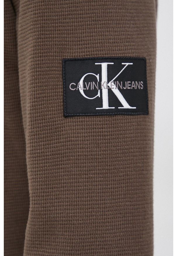 Calvin Klein Jeans Sweter bawełniany kolor zielony. Okazja: na co dzień. Kolor: zielony. Materiał: bawełna. Długość: krótkie. Wzór: aplikacja. Styl: casual