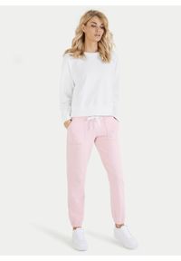 Różowe bawełniane spodnie dresowe ze ściągaczami Juvia. Kolor: różowy. Materiał: dresówka, bawełna #1