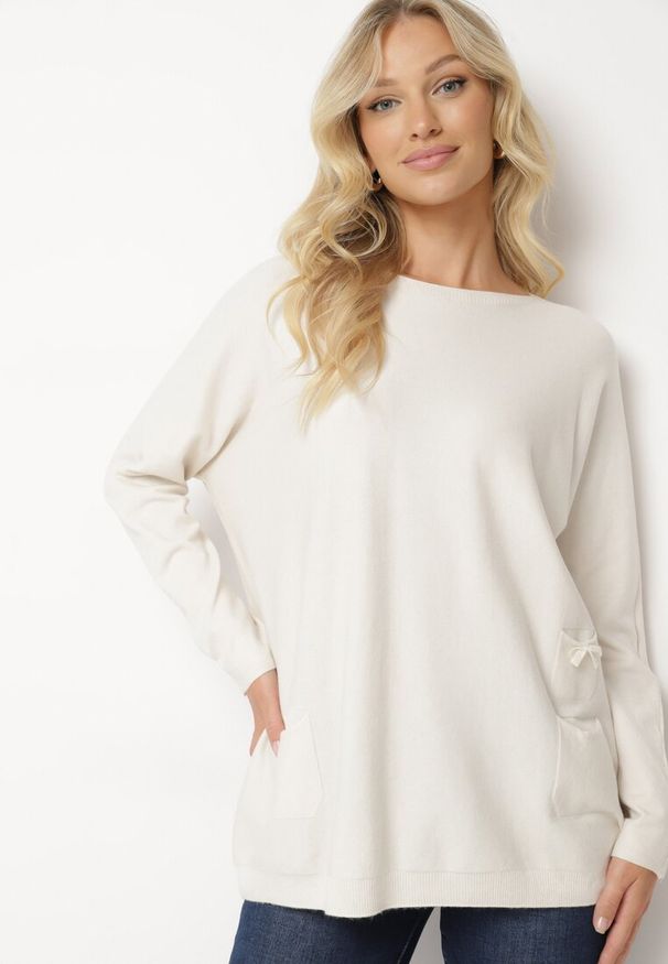 Born2be - Jasnobeżowy Sweter z Wiskozą Ozdobiony Wsuwanymi Kieszonkami i Kokardą Omeza. Okazja: na co dzień. Typ kołnierza: kokarda. Kolor: beżowy. Materiał: wiskoza. Długość rękawa: długi rękaw. Długość: długie. Wzór: aplikacja. Styl: elegancki, casual