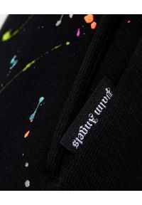 PALM ANGELS - Czarne spodnie dresowe z efektem ubrudzenia farbą. Kolor: czarny. Materiał: dresówka. Wzór: nadruk, kolorowy