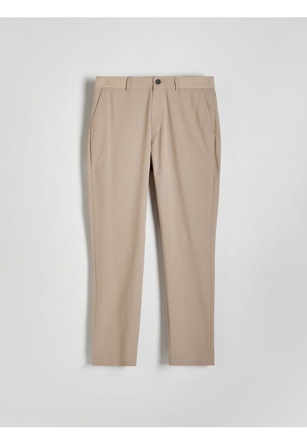 Reserved - Spodnie slim fit - beżowy. Kolor: beżowy. Materiał: tkanina, wiskoza
