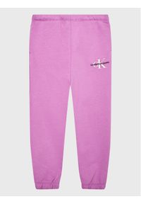 Calvin Klein Jeans Spodnie dresowe Monogram Off Placed IG0IG01854 Fioletowy Relaxed Fit. Kolor: fioletowy. Materiał: bawełna #1
