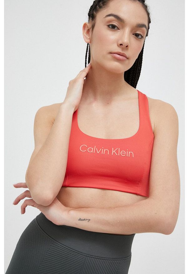 Calvin Klein Performance biustonosz sportowy Essentials kolor pomarańczowy. Kolor: pomarańczowy. Materiał: skóra. Sport: fitness, taniec