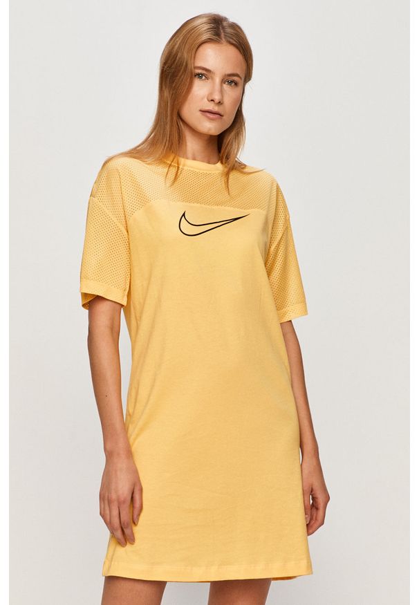 Nike Sportswear - Sukienka. Okazja: na co dzień. Kolor: żółty. Materiał: bawełna, dzianina. Długość rękawa: krótki rękaw. Wzór: nadruk. Typ sukienki: proste. Styl: casual. Długość: mini