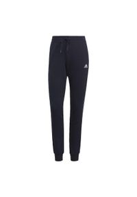 Adidas - Spodnie damskie adidas Essentials Slim Tapered Cuffed Pant. Kolor: biały, wielokolorowy, niebieski. Materiał: dresówka, bawełna, materiał. Długość: długie
