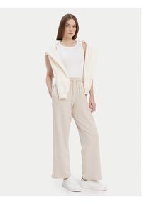 TOMMY HILFIGER - Tommy Hilfiger Spodnie dresowe UW0UW04771 Beżowy Relaxed Fit. Kolor: beżowy. Materiał: dresówka #3