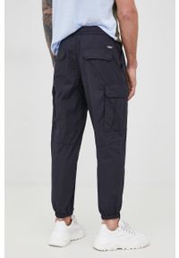 Armani Exchange spodnie dresowe bawełniane męskie kolor granatowy gładkie. Kolor: niebieski. Materiał: bawełna, dresówka. Wzór: gładki