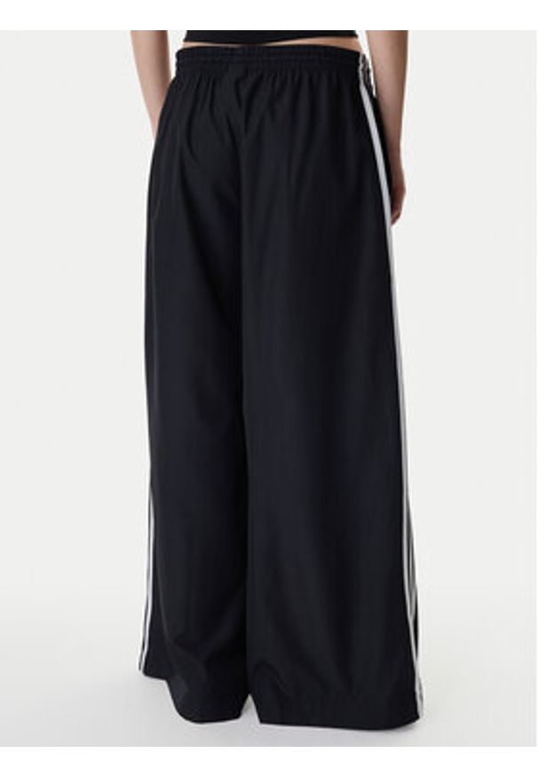 Adidas - adidas Spodnie dresowe Firebird Adilenium KD2914 Czarny Regular Fit. Kolor: czarny. Materiał: syntetyk