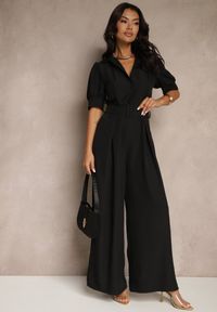 Renee - Czarny Kombinezon Taliowany Ozdobiony Klamrą Filenala. Kolor: czarny. Wzór: aplikacja. Styl: elegancki