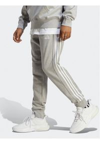 Adidas - adidas Spodnie dresowe Essentials French Terry Tapered Cuff 3-Stripes Joggers IC9407 Szary Regular Fit. Kolor: szary. Materiał: bawełna, dresówka