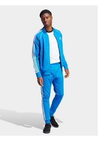 Adidas - adidas Spodnie dresowe adicolor Classics SST IM4542 Niebieski Slim Fit. Kolor: niebieski. Materiał: bawełna, syntetyk