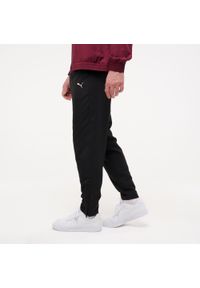 Spodnie dresowe męskie Puma Woven Gym & Pilates. Kolor: czarny. Materiał: dresówka. Sport: joga i pilates
