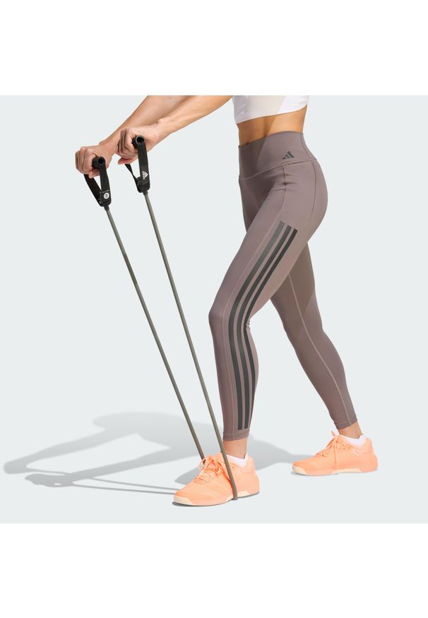 Adidas - Legginsy Optime Workout 3-Stripes 7/8. Stan: podwyższony. Kolor: szary, wielokolorowy, brązowy. Materiał: skóra, materiał. Sport: fitness