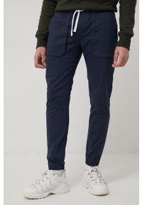 Tommy Jeans spodnie SCANTON męskie kolor granatowy joggery. Kolor: niebieski. Materiał: materiał, bawełna, tkanina. Wzór: gładki
