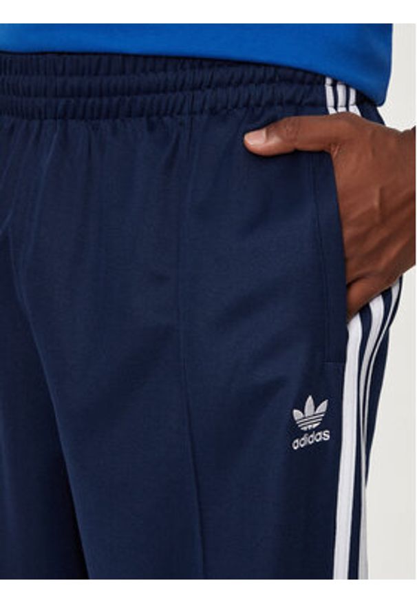 Adidas - adidas Spodnie dresowe adicolor Firebird IZ2466 Granatowy Baggy Fit. Kolor: niebieski. Materiał: syntetyk