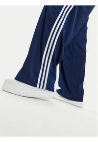 Adidas - adidas Spodnie dresowe Firebird IL3817 Granatowy Loose Fit. Kolor: niebieski. Materiał: syntetyk #3