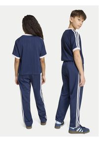 Adidas - adidas Spodnie dresowe Firebird HZ6650 Granatowy Regular Fit. Kolor: niebieski. Materiał: syntetyk #4